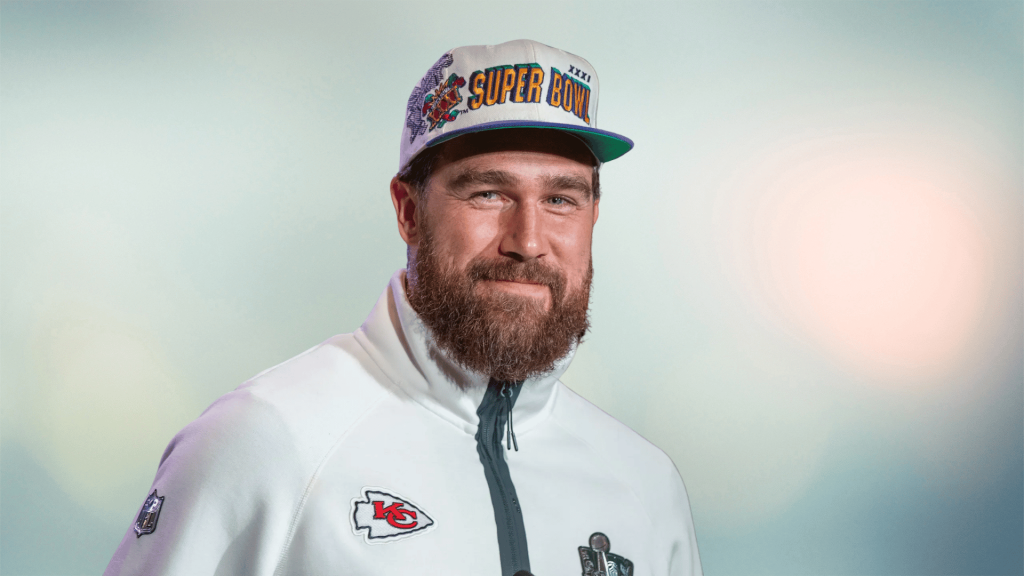 Travis Kelce posing in chiefs gear highlighting his football career