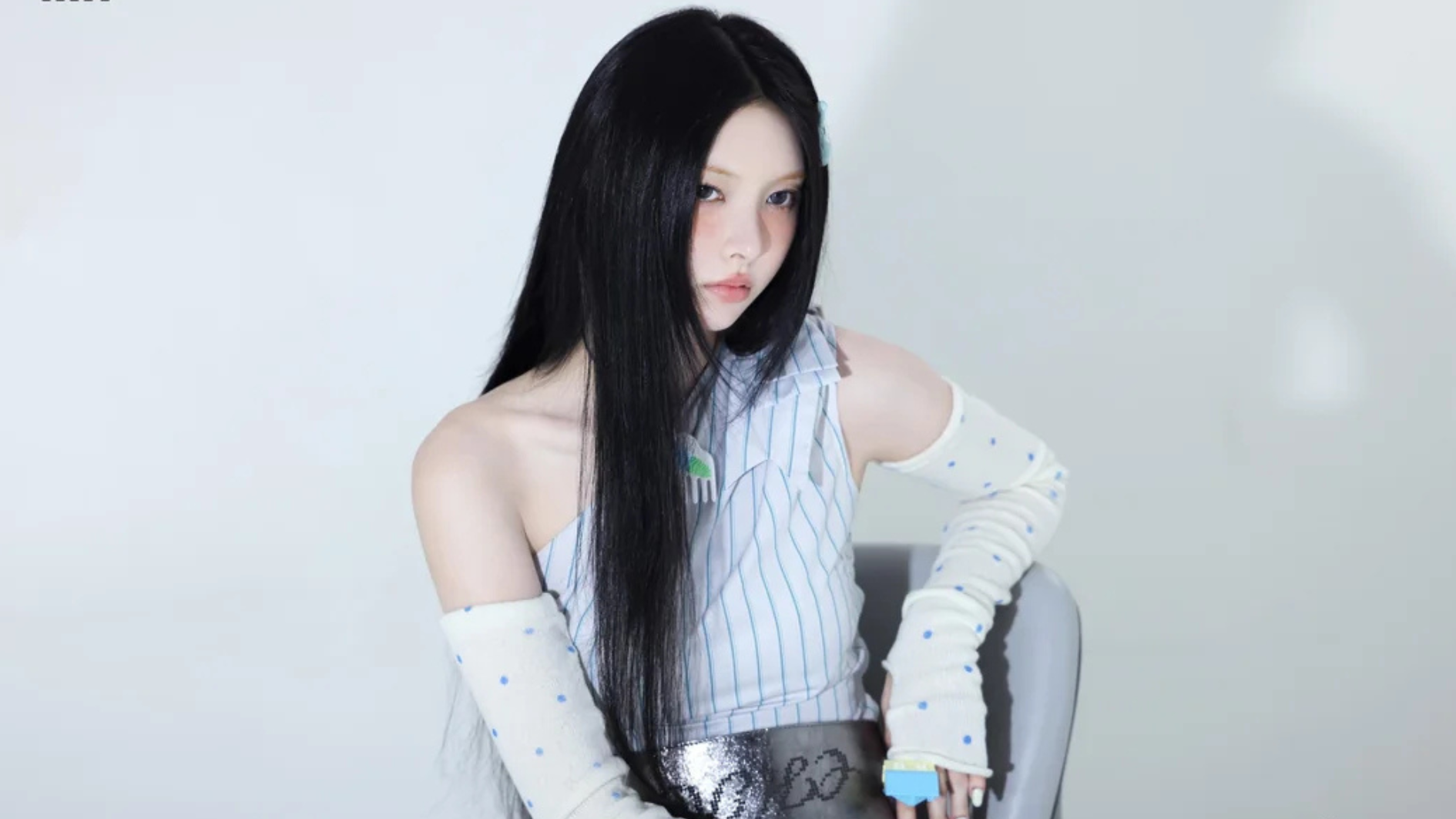 yunah of illit posing with long black hair