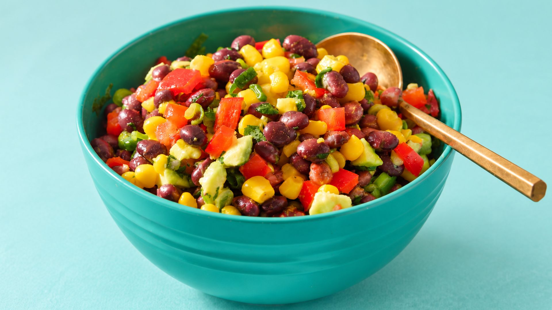 Black bean and corn salad with tomato, red onion, avocado, cilantro and fresh lime.