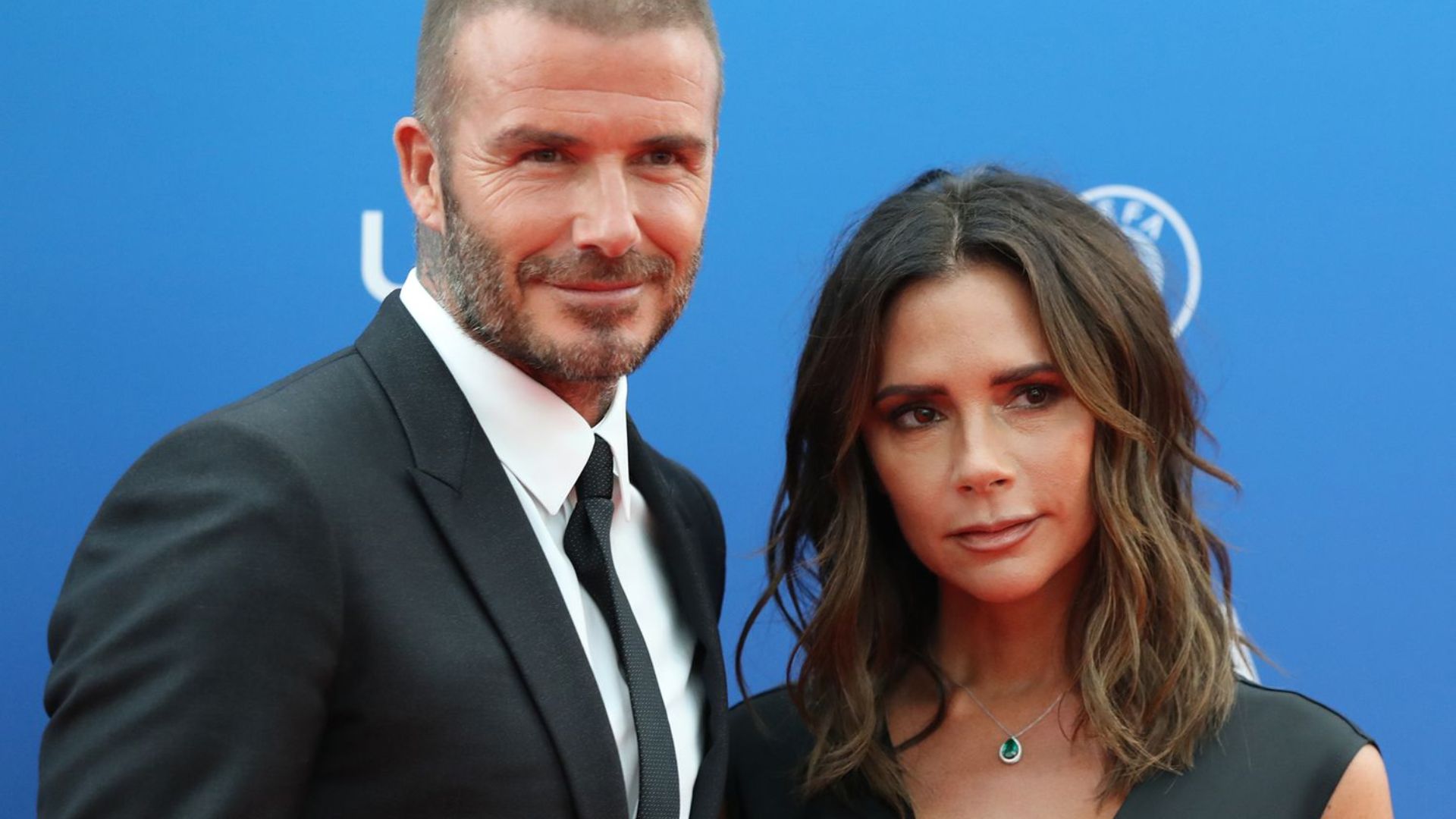 David Beckham and Victoria Beckham posing together at a formal event.