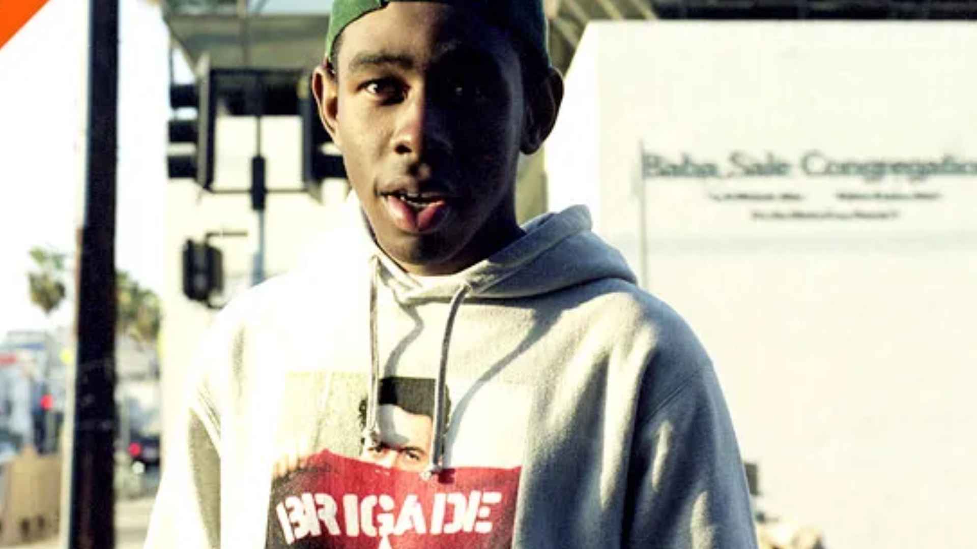 Tyler, The Creator in a casual hoodie and cap during his early career before gaining fame.