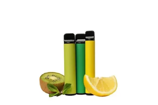 Three colorful vape pens with sliced kiwi and lemon on white background