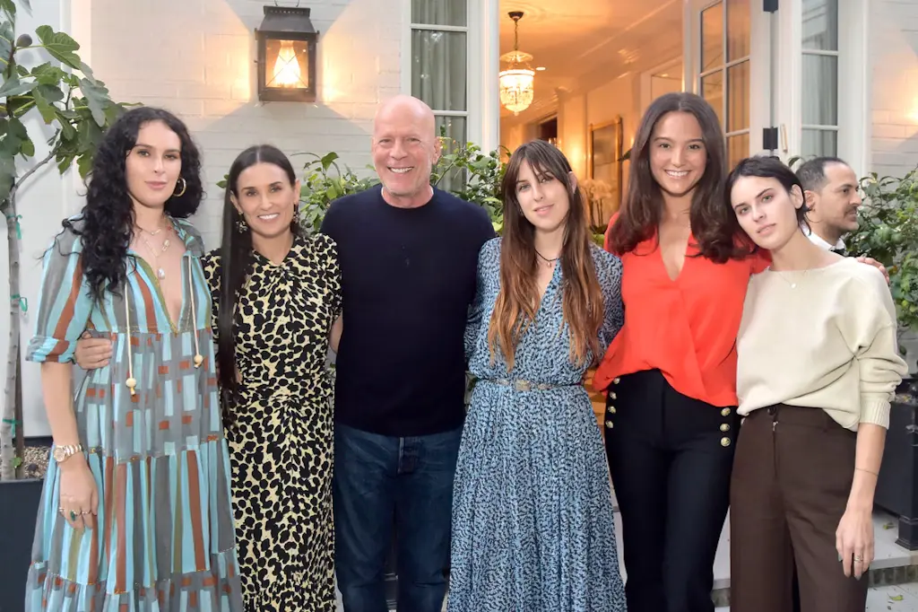 bruce willis standing with demi moore and four women outside a home during a group gathering