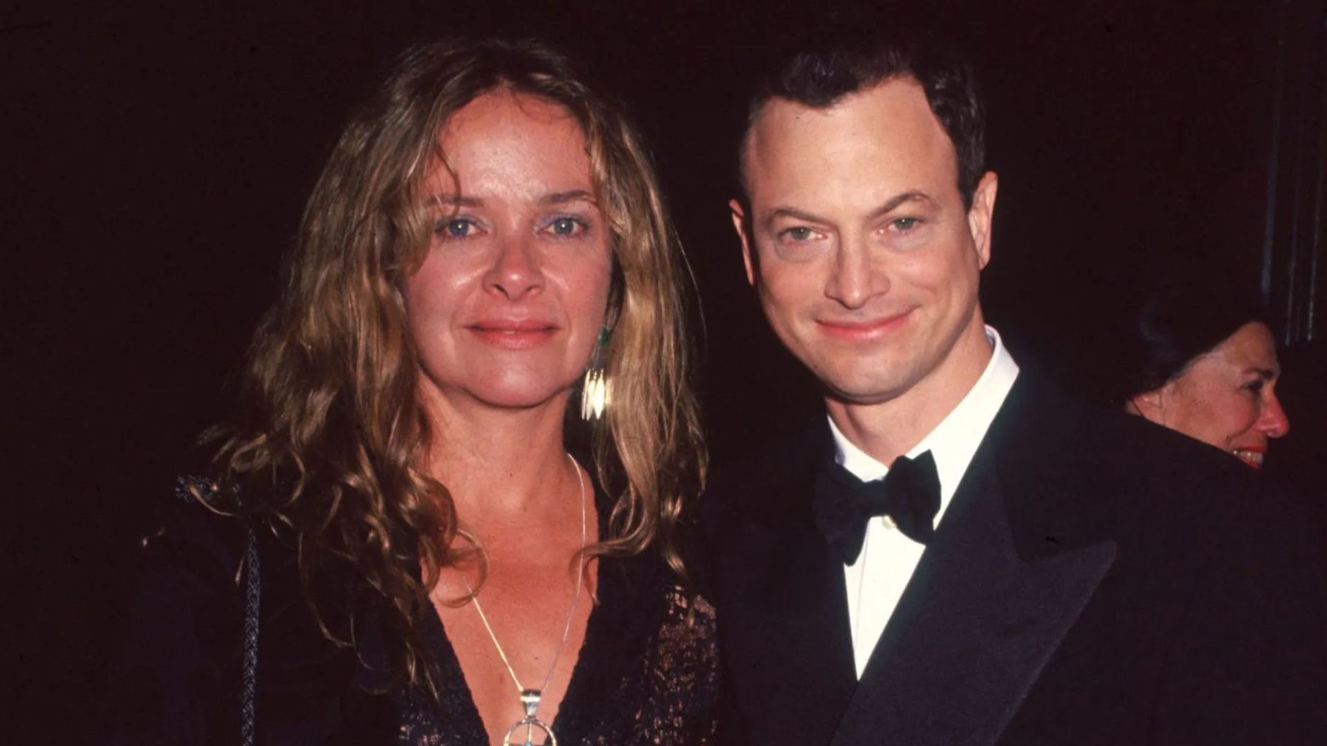 Gary Sinise with his wife Moira Harris posing together at a formal event.