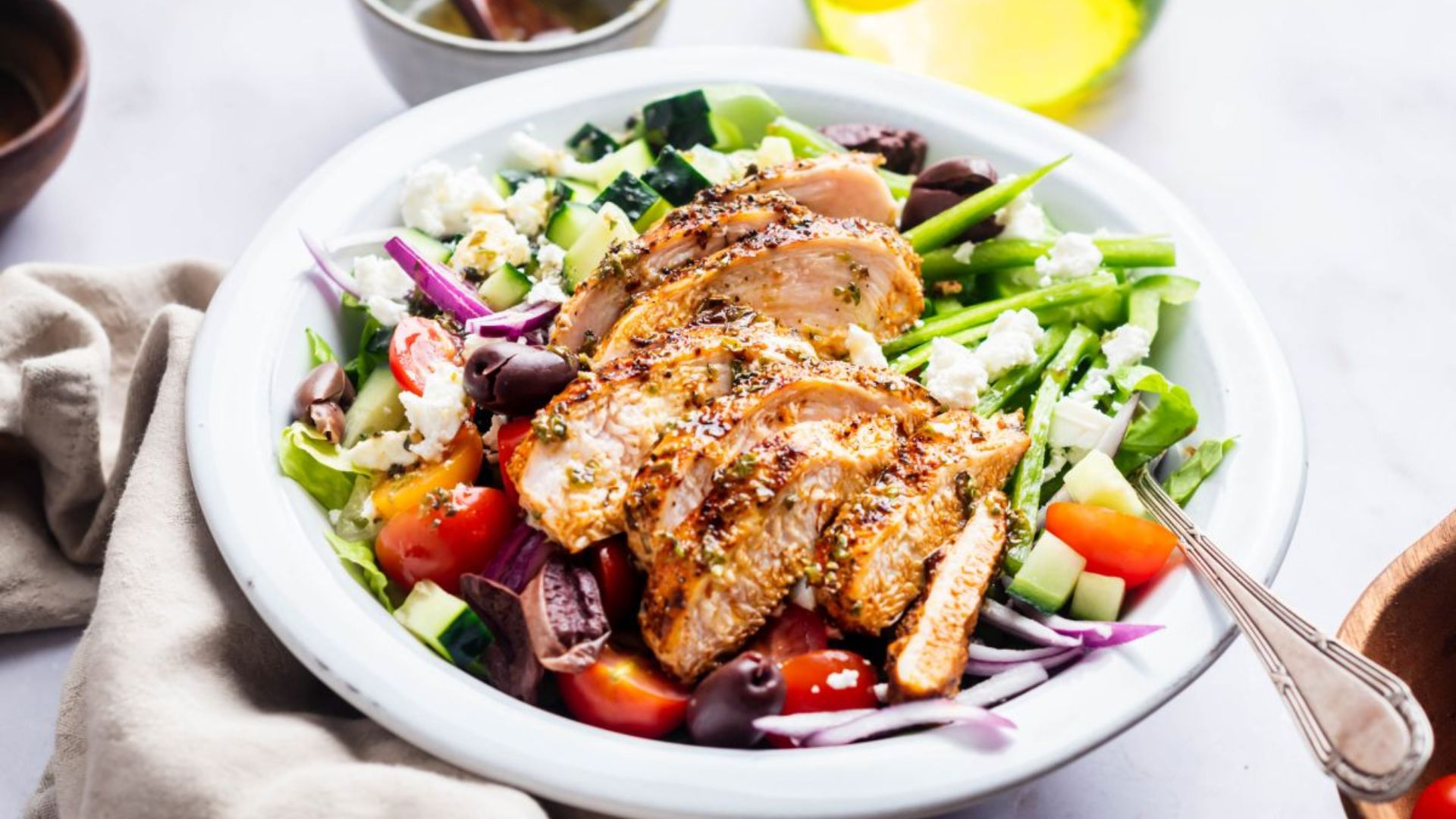 Grilled chicken Greek salad with romaine, cucumber, tomato, olives, feta and red onion.