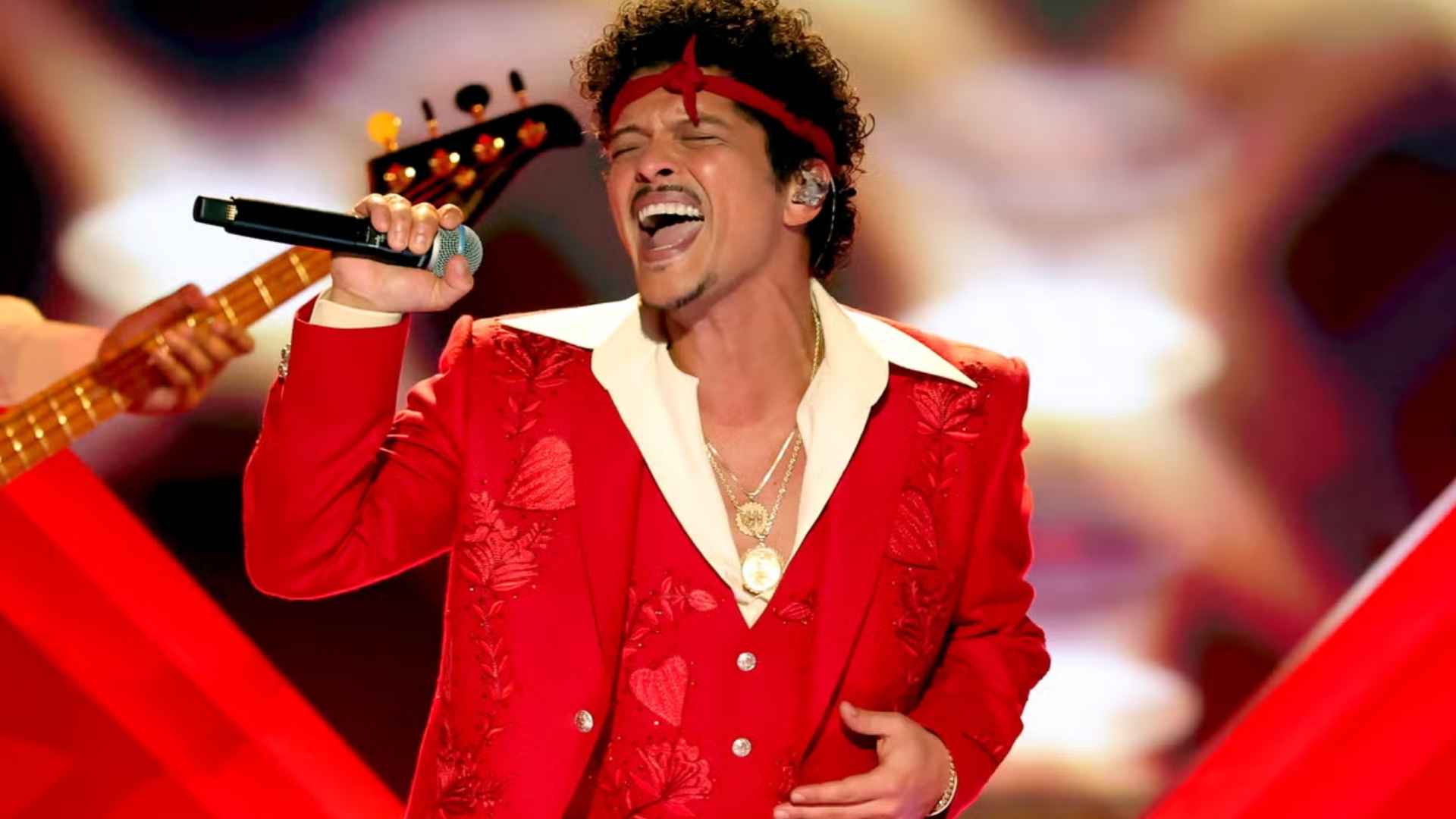 Bruno Mars performing live on stage during The Romantic Tour in a red outfit