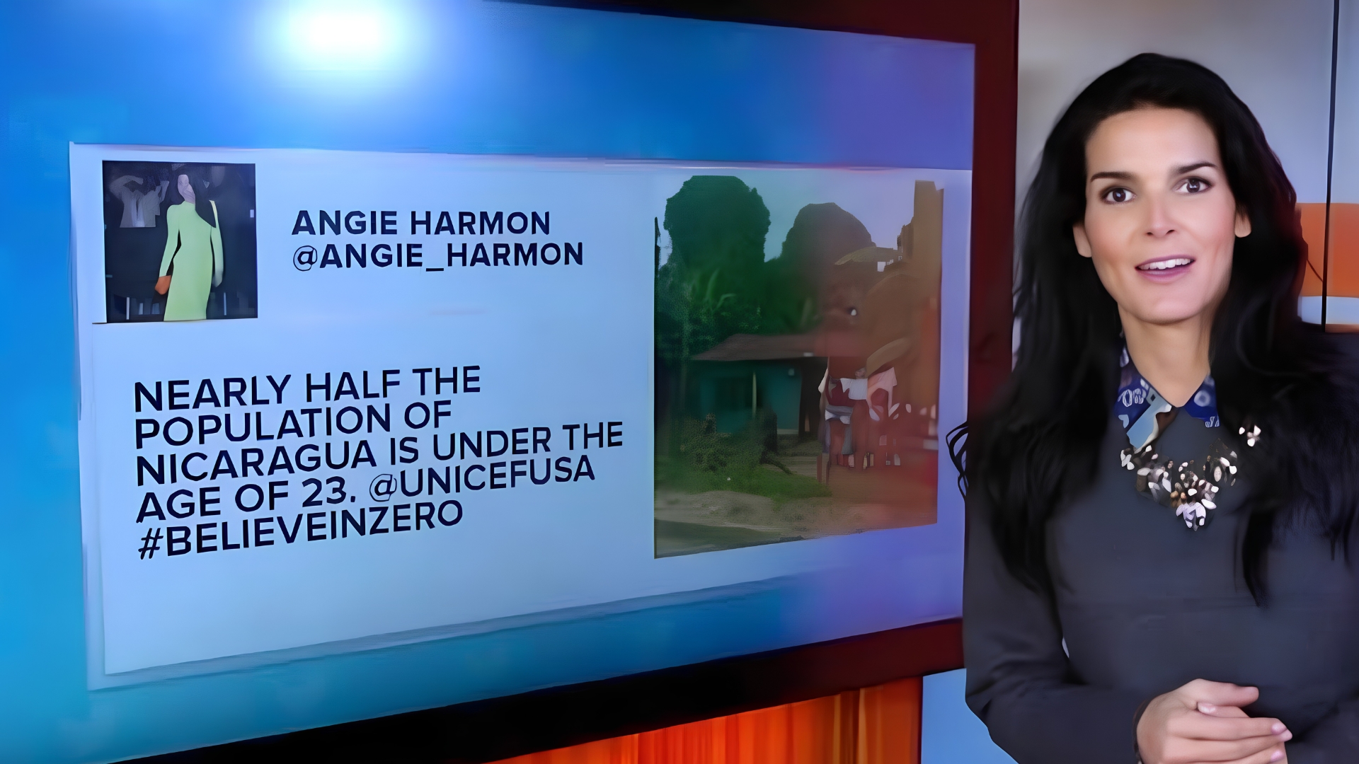 Angie Harmon standing on a studio set next to a screen displaying her tweet about UNICEF USA.