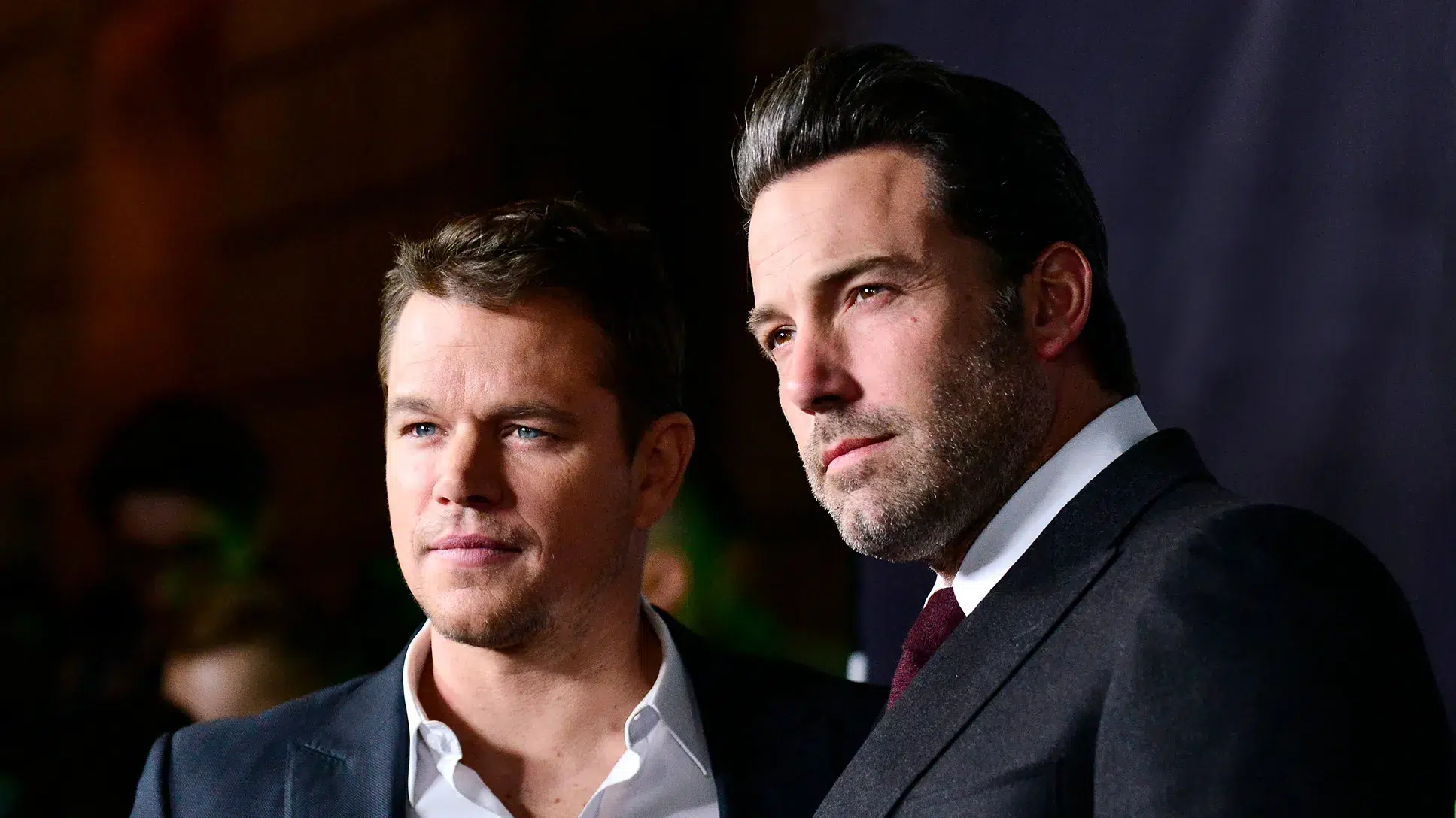 matt damon and ben affleck wearing suits at a public event together