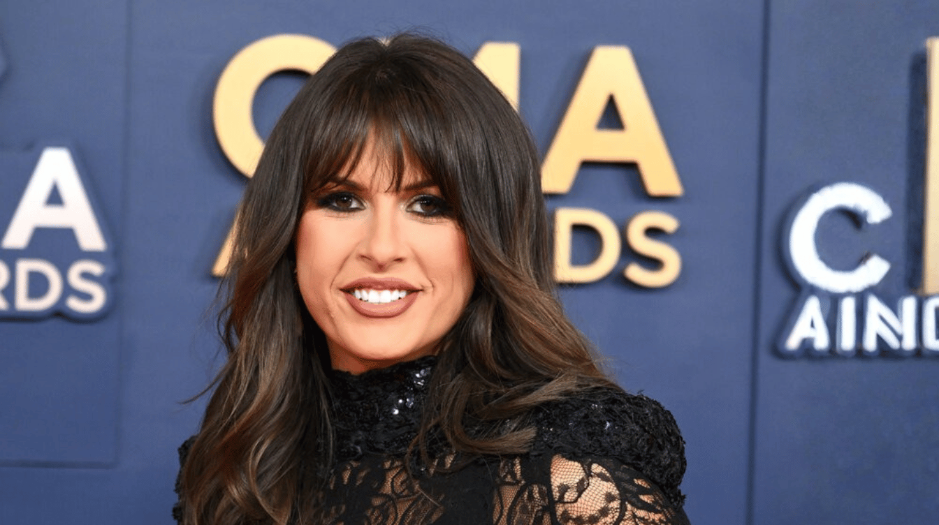 ella langley smiling at the cma awards red carpet in a black lace outfit