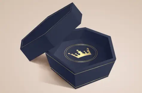 Luxurious navy blue hexagonal gift box with open lid and gold crown emblem inside