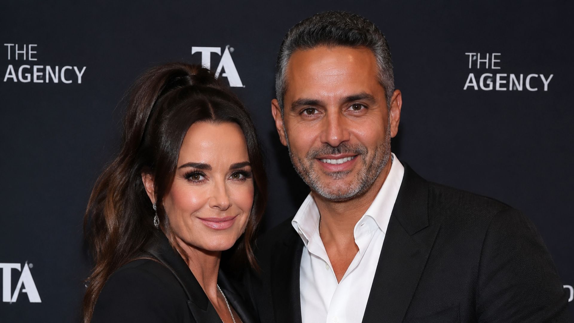 Kyle Richards and Mauricio Umansky posing together at a public event, highlighting their relationship and connection to The Agency real estate business.