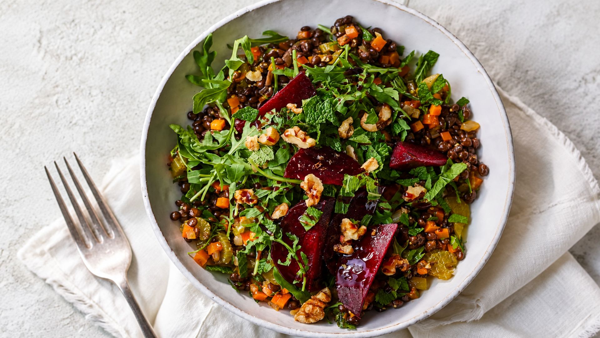 Lentil vegetable salad with cucumber, tomatoes, spinach, parsley and crumbled feta.