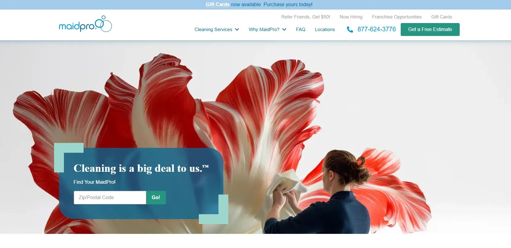 Person cleaning large sculptural flower with cloth in a minimalist setting