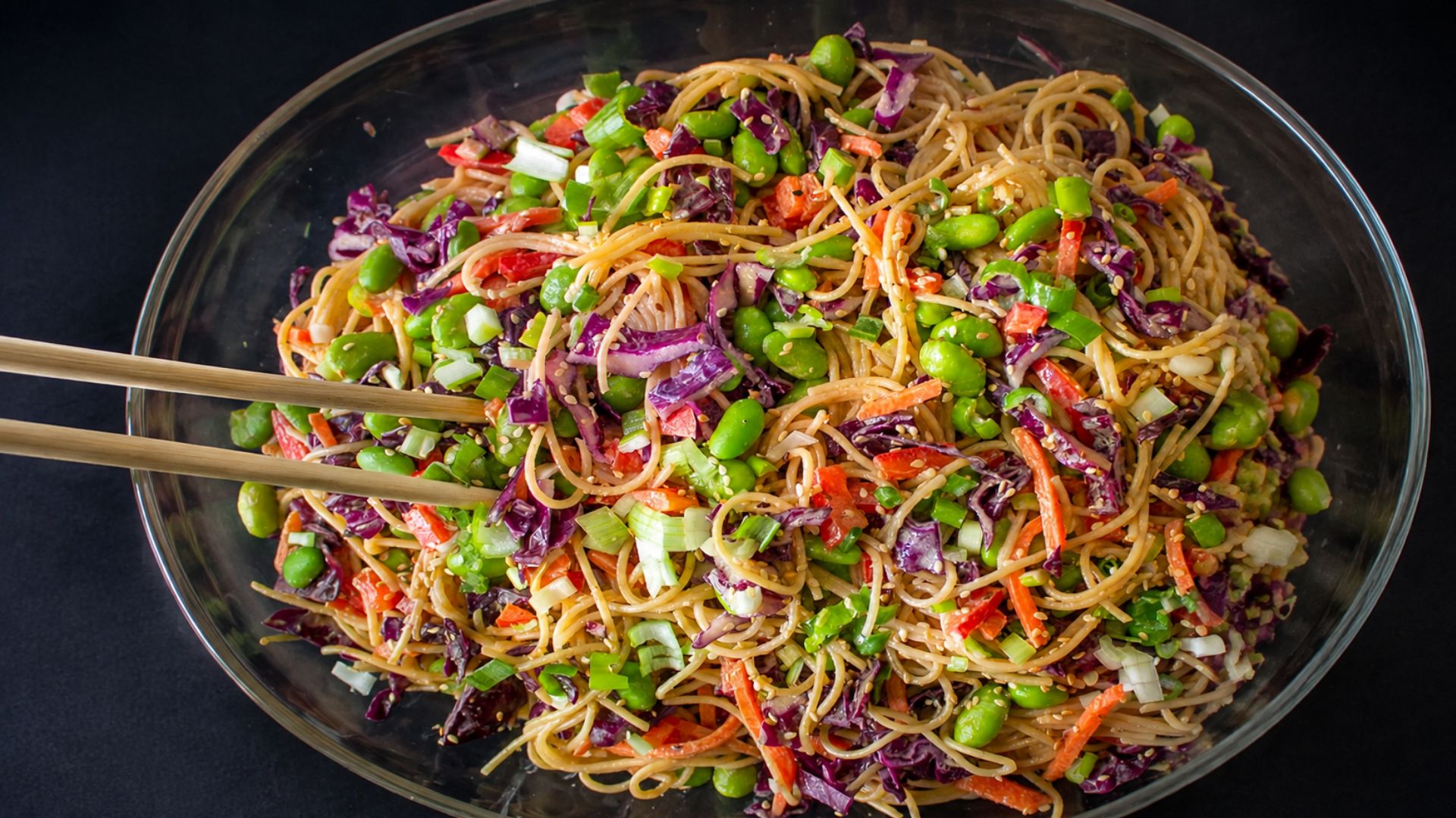 Peanut noodles with carrots, cabbage, cucumber, bell pepper, edamame, peanuts and lime.