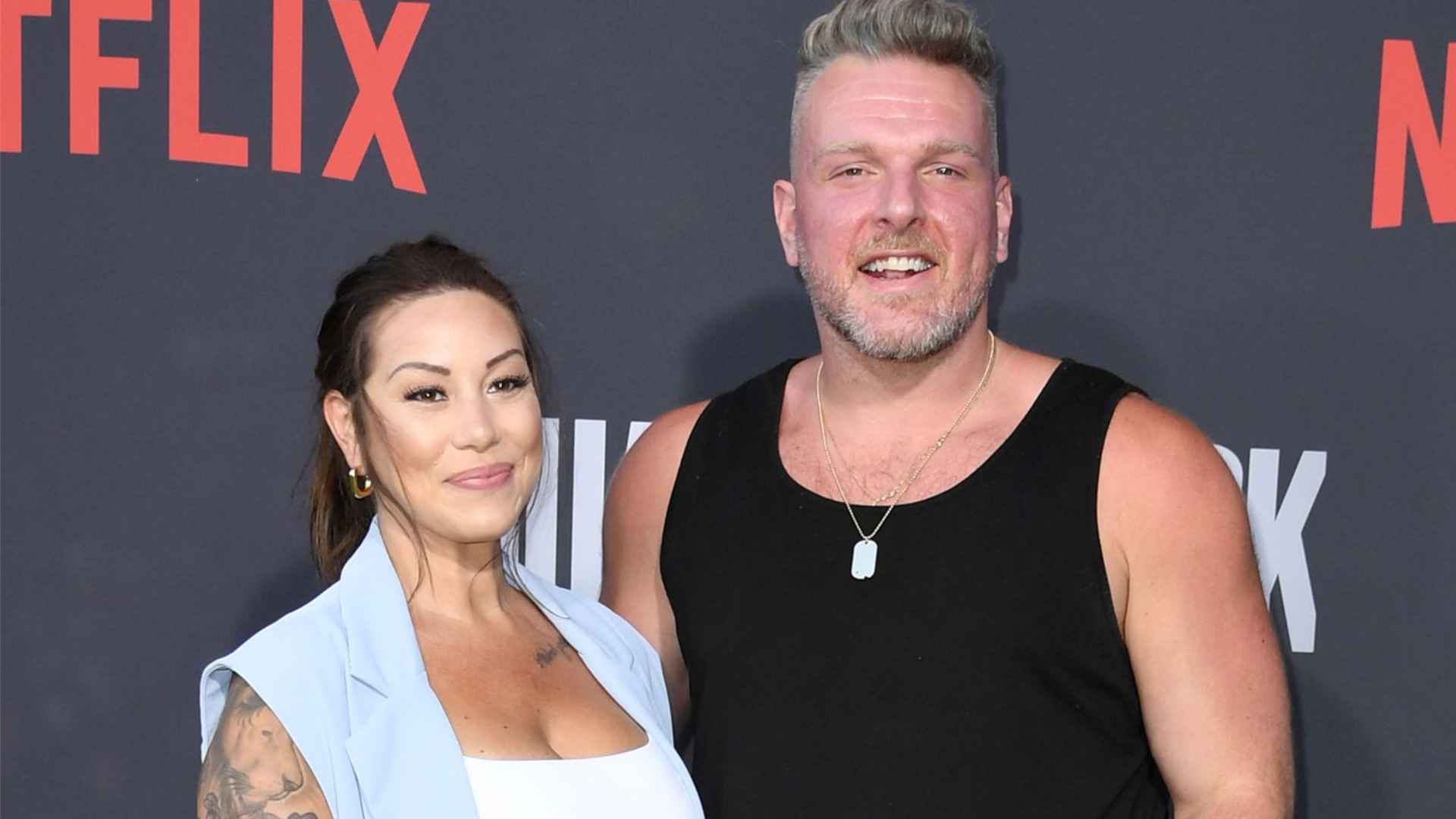 Pat McAfee and Samantha Ludy posing together at a Netflix event red carpet