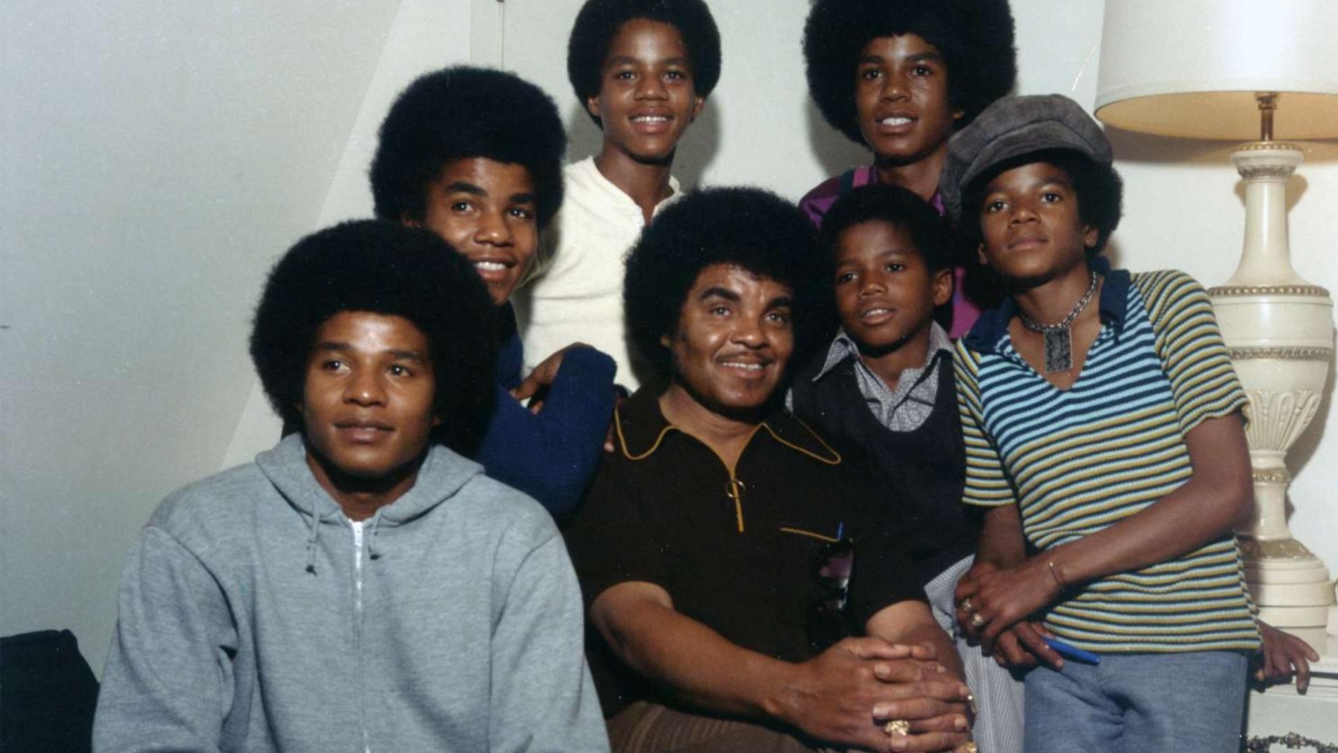 Young Randy Jackson with Michael Jackson and members of the Jackson family in a vintage family photo.