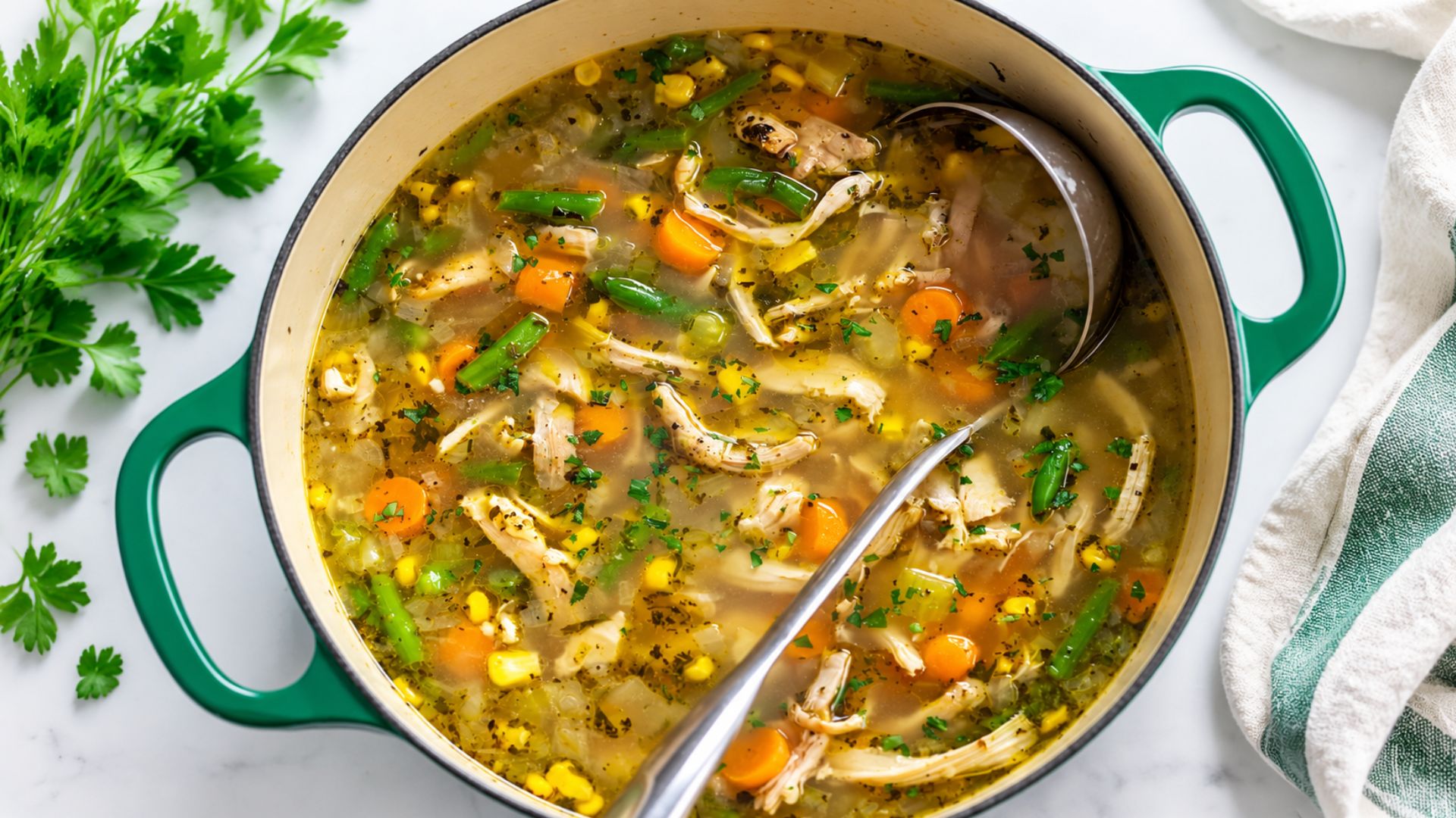 Rotisserie chicken vegetable soup with shredded chicken, carrots, celery, spinach and noodles.