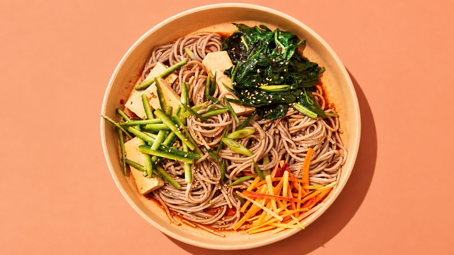 Sesame soba noodle salad with edamame, carrots, cucumber, purple cabbage and scallions.