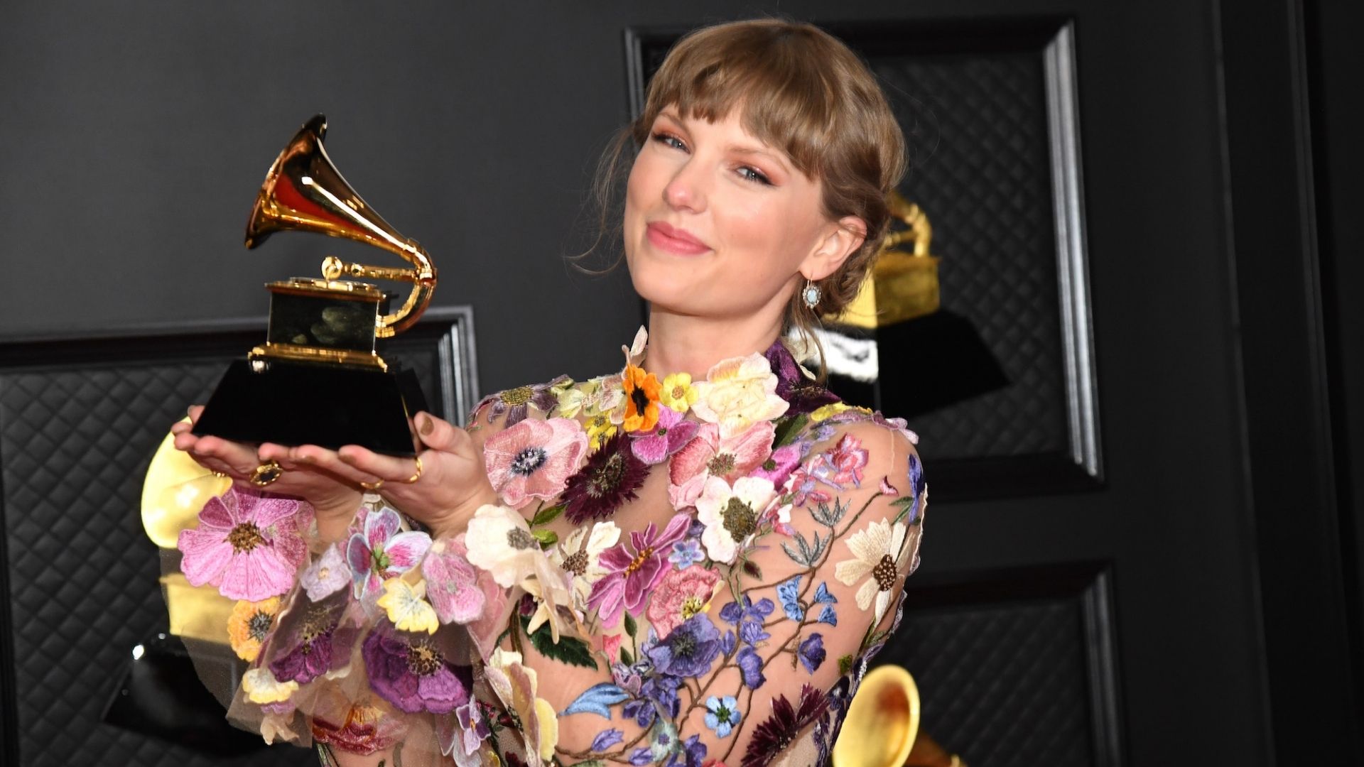 Taylor Swift holding a Grammy award at the 63rd Annual Grammy Awards