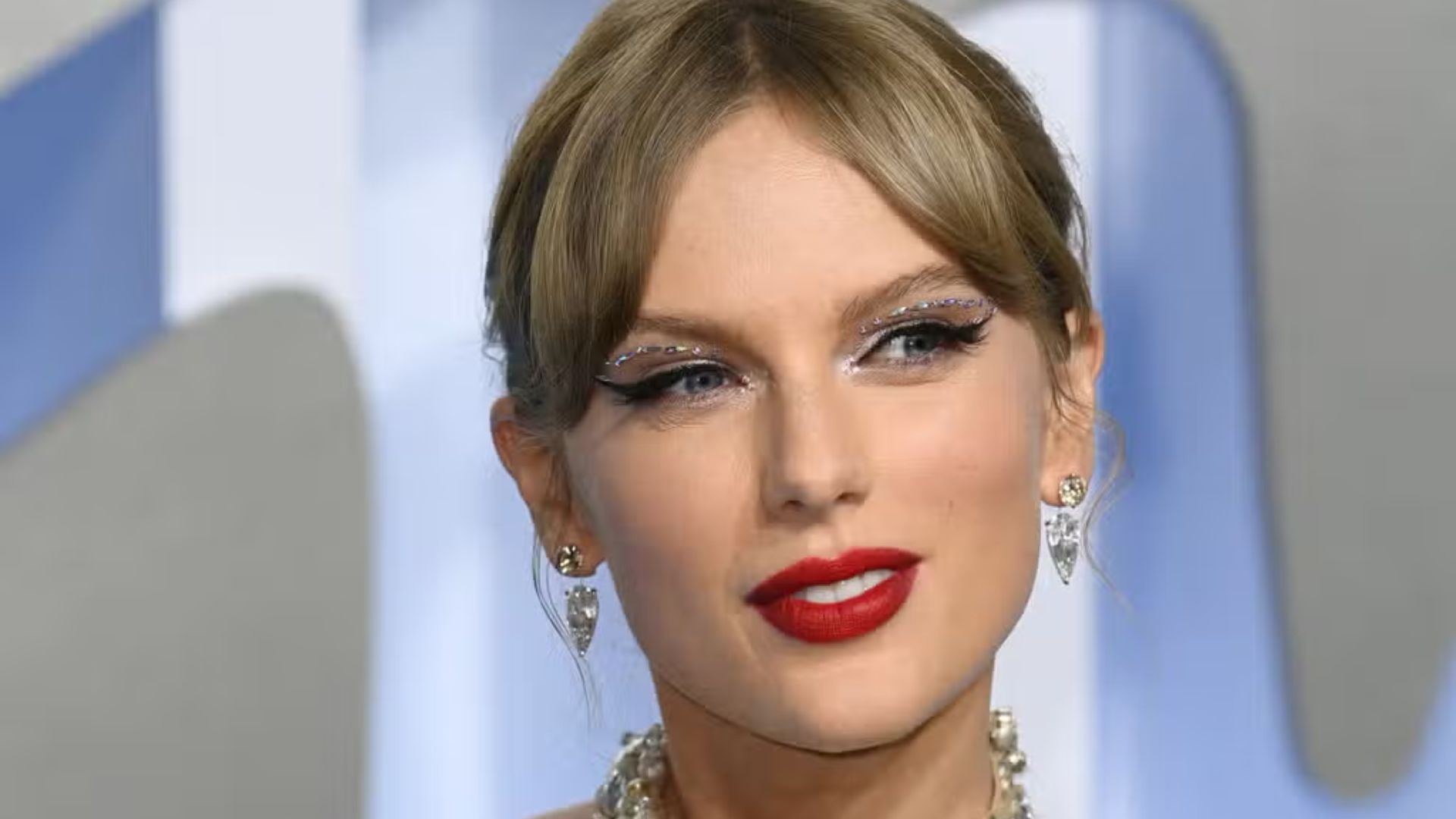 Taylor Swift close-up portrait highlighting her red carpet makeup, hairstyle, and appearance during a recent public event.