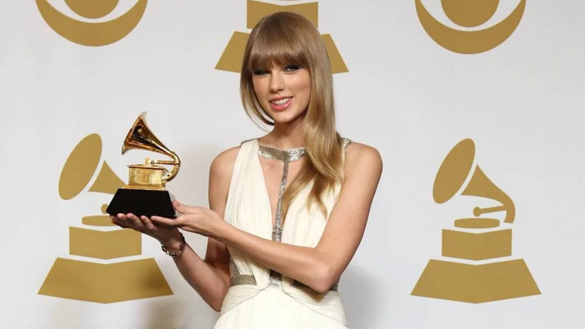 Taylor Swift holding her Grammy Award for Best Song Written for Visual Media for "Safe & Sound" at the 55th Annual Grammy Awards
