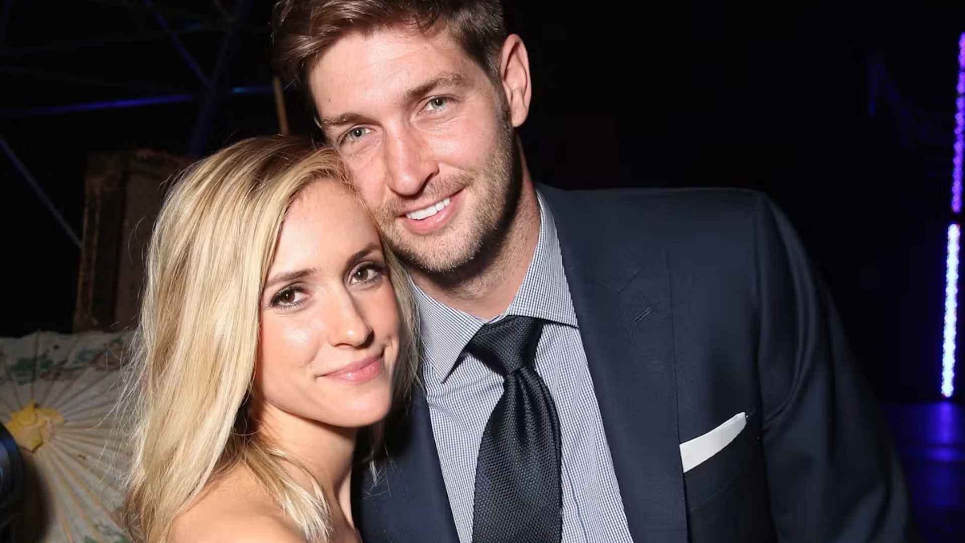 Kristin Cavallari posing closely with Jay Cutler in a dark suit and tie at an evening event.