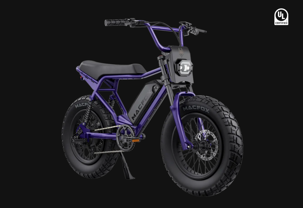 Purple electric bike with thick tires and ergonomic seat on black background