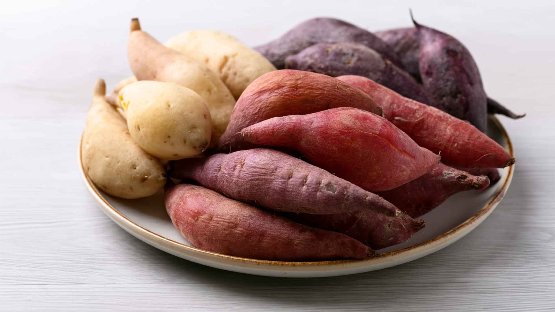 sweet potatoes with red skin served on a gray ceramic plate