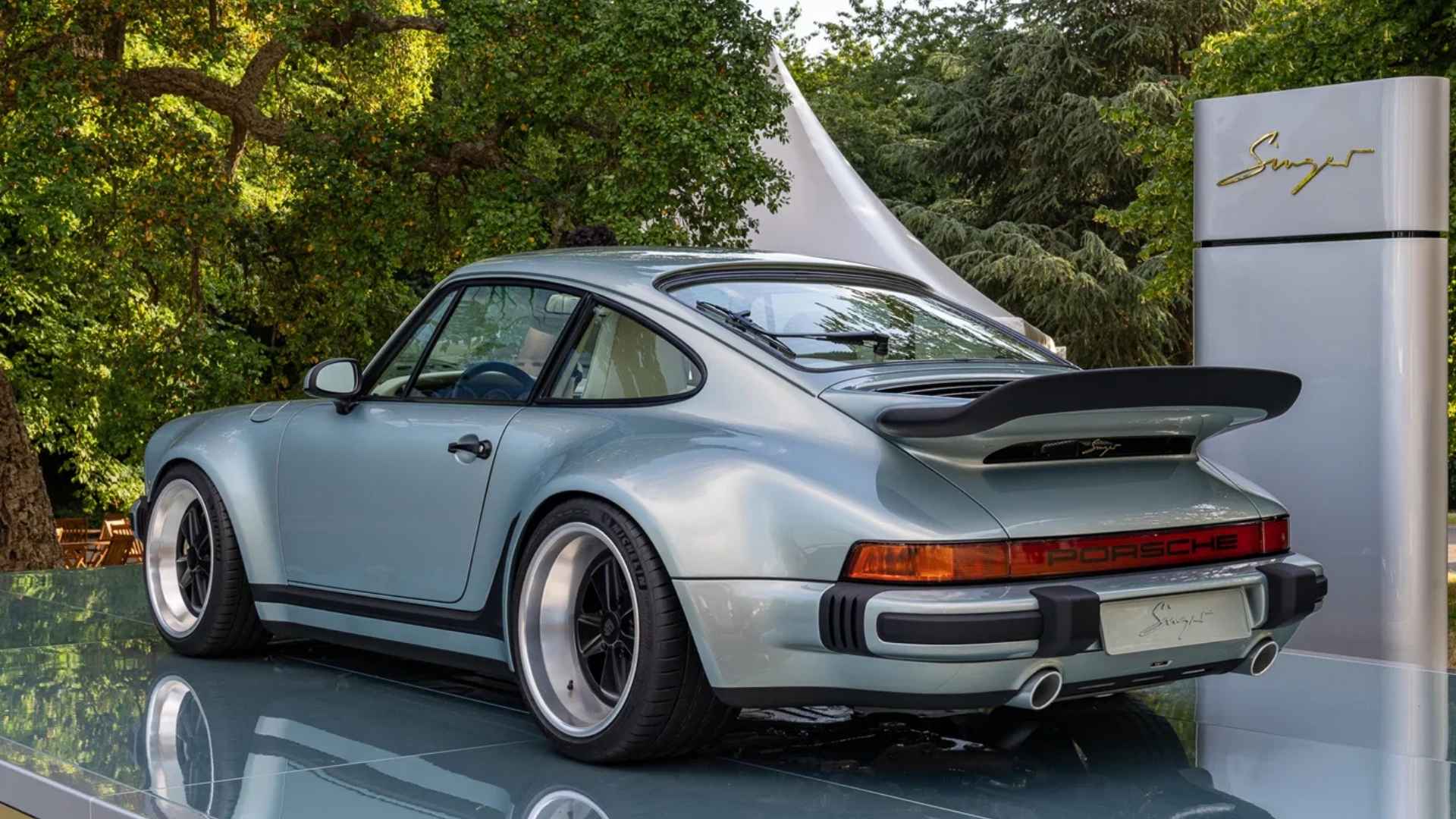 Singer Turbo Study Porsche 911 in pale blue, shown from rear with wide fenders and a large rear wing