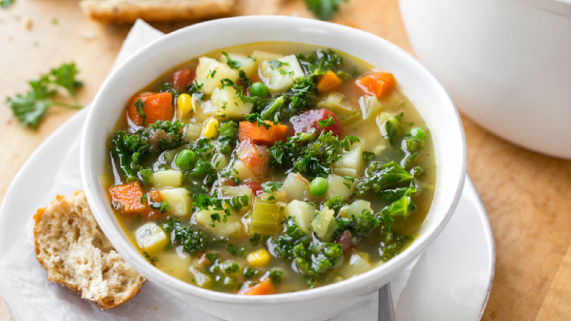 Vegetable soup with carrots, celery, zucchini, tomatoes, white beans and spinach in a light broth.