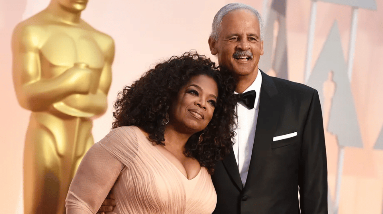oprah winfrey poses with stedman graham at a formal awards event with an oscar statue behind them